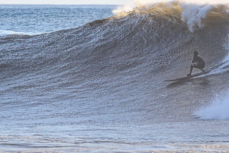 Surfer on a beautiful sunny day in the surf of the ocean