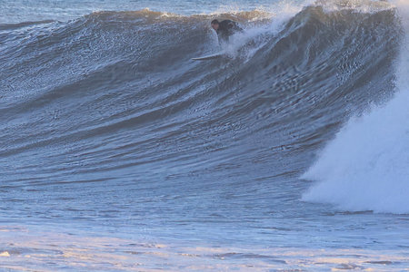 Surfer on a Blue Ocean Wave at Sunset, California, USA