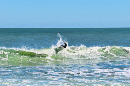 Surfer in action on the ocean waves on a sunny day.の写真素材