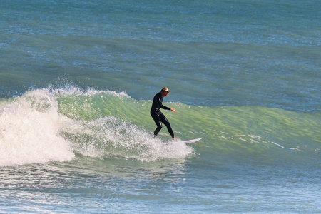 Surfer in action on the ocean waves on a sunny day.の写真素材
