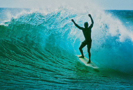 Surfer on Blue Ocean Wave, Bali island, Indonesia.