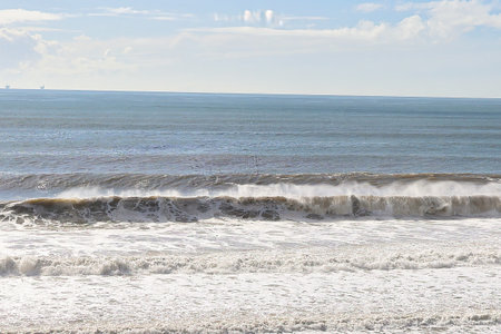Seascape with stormy sea and blue sky in the background