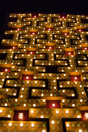 Lighted candles in the shape of a square in the night.の写真素材