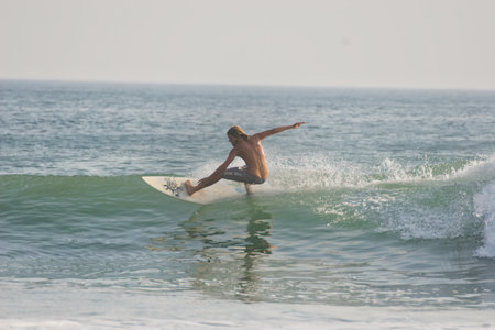 Surfer in action at the beach on a beautiful sunny day.の写真素材