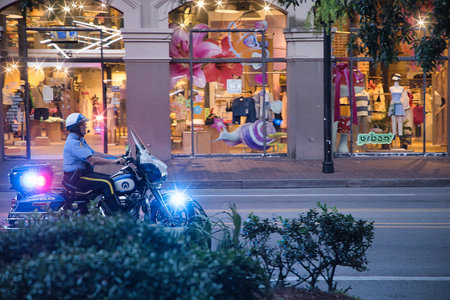 A motorcyclist riding a motorbike in Bangkok, Thailand.の写真素材
