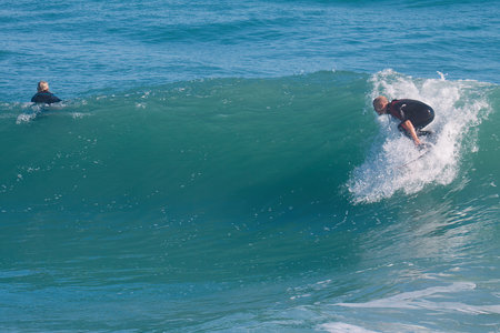 Surfer in action on the ocean wave on a sunny day.の写真素材