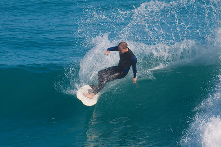 Surfer in action at the beach on a beautiful sunny day.