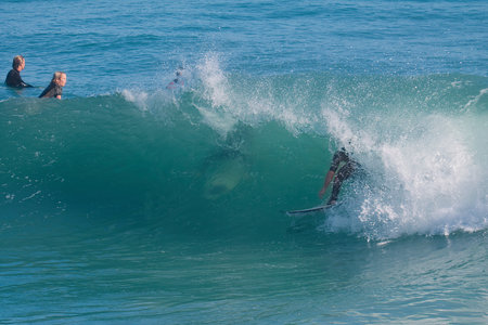 Surfer in action on the ocean wave on a sunny day.