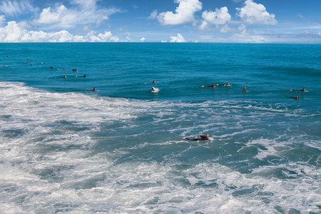 Surfers and surfers in the sea on a sunny dayの写真素材