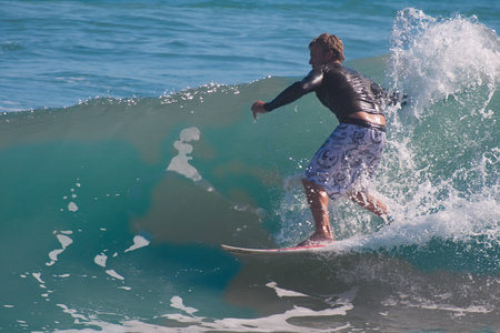 Surfer in action on the ocean wave on a sunny day.