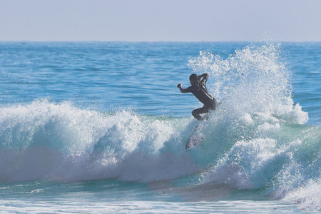 Surfer in action on the ocean waves on a sunny day.の写真素材