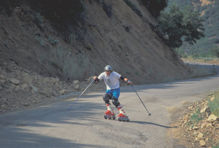 Person riding on roller skates on the road in the mountains.の写真素材