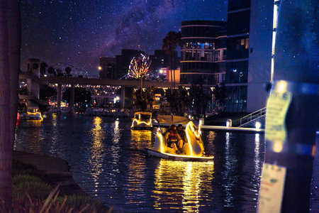 Night view of a canal with boats and buildings at nightの写真素材