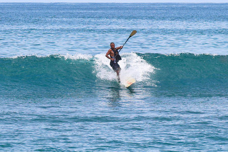 Surfer in action on the ocean waves on a sunny day.の写真素材