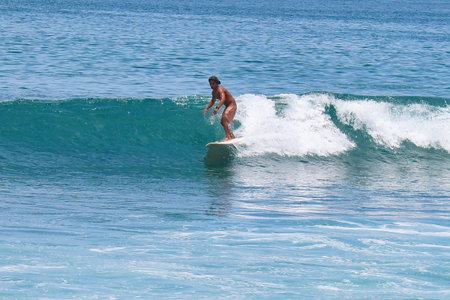 Surfer on Amazing Blue Wave at Bali island, Indonesia.の写真素材