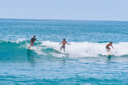 Surfer on the wave at the beach of Oahu, Hawaii