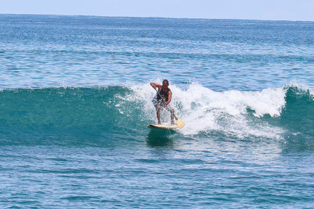 Surfer on Amazing Blue Wave at Bali island, Indonesia.の写真素材