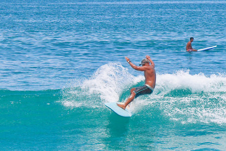Surfer in action on the ocean wave on a sunny day.