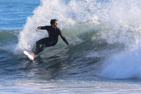 Surfer in action on the ocean waves on a sunny day.