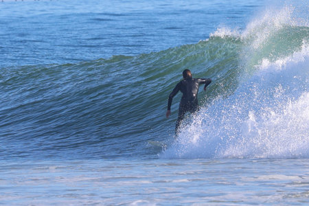 Surfer in action on the ocean wave on a sunny day.の写真素材
