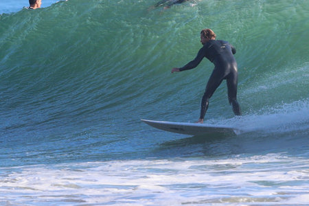 Surfer in action on the ocean wave on a sunny day.