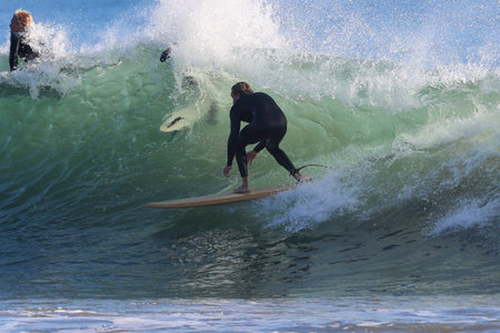Surfer in action on the beach of Surfers Paradise on the Gold Coast of Australia.