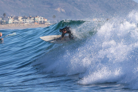 Surfer in action on the ocean wave on a sunny day.