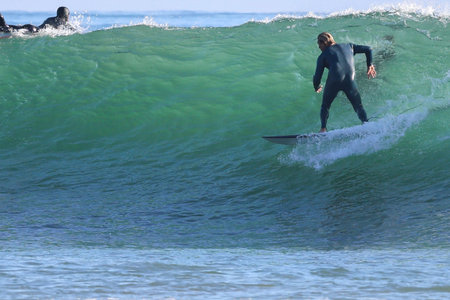 Surfer in action on the ocean wave on a sunny day.