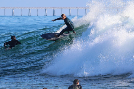 Surfer in action on the ocean wave on a sunny day.
