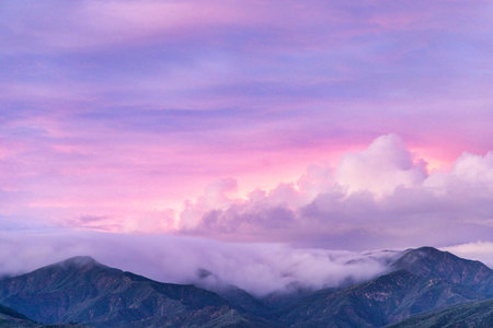 Mountains in the clouds at sunset. Beautiful natural landscape with mountains.