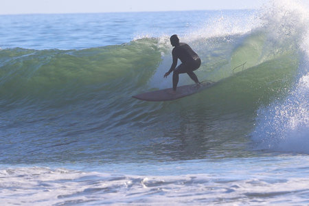 Surfer in action on the ocean wave on a sunny day.の写真素材