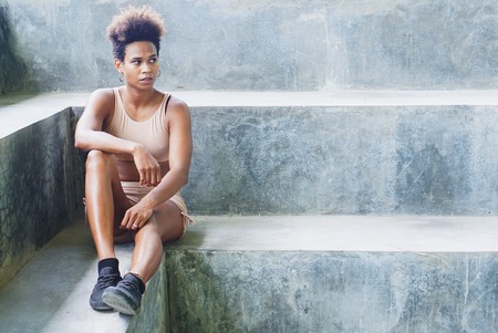 Melanesian pacific islander athlete girl with afro after workout performing exercising routines