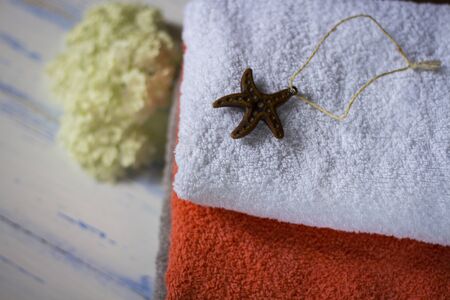 Bath towels of different colors on a wooden table.の写真素材