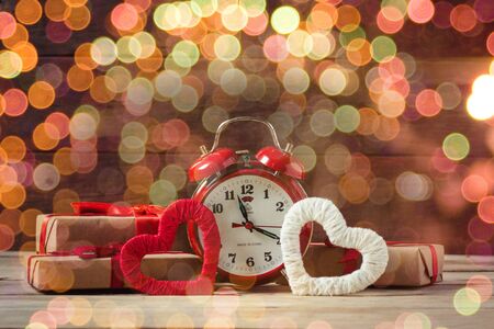 Packaged gifts, two hearts handmade and red watches. Bokeh.の写真素材