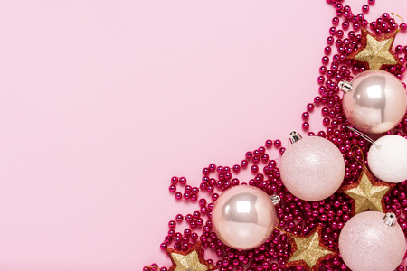 Christmas decorations, balls, festoon on a light pink background. Merry Christmas and Happy New Year concept. Flat lay, top view.の写真素材
