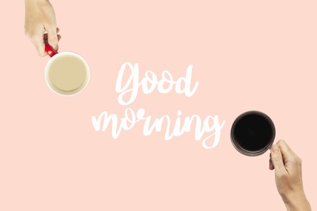 Many hands are holding cups of coffee on a pink background. Concept breakfast with friends, friendly...