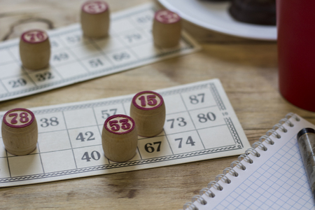 Bingo. Kegs and cards  with bingo on wood background.