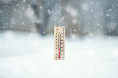 The thermometer in the snow, shows the temperature of Zero during the time of the Snow Storm. Winter. Snow storm. Snowfall.の写真素材