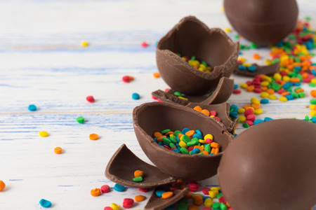 Easter Chocolate Eggs, Multicolored Sweets on the Old White Wooden Background. Easter concept.
