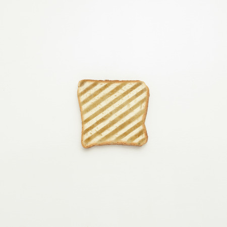 Slice of toast in stripes on white background