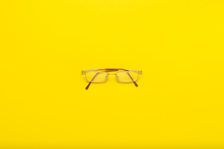 Eye glasses on a yellow background. Flat lay, top view.の写真素材