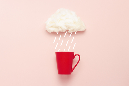 Red dagger a cloud of cotton wool and rain drops on a pink background. Concept of hot coffee or tea in rainy weather. Flat lay top viewの写真素材