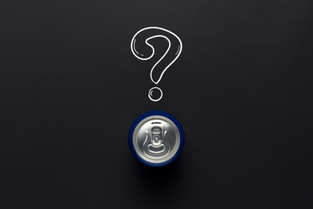 Tin can with a drink on a black background with a question mark. minimalism. Concept of an unknown...