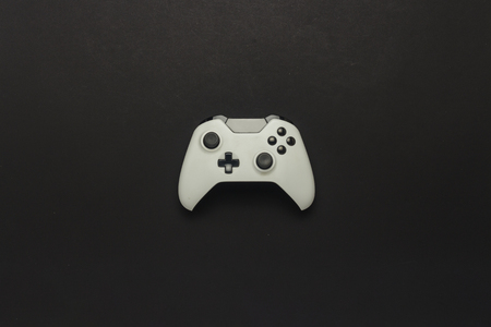 White gamepad on a black background. Concept game on the console, computer games. Flat lay, top viewの写真素材