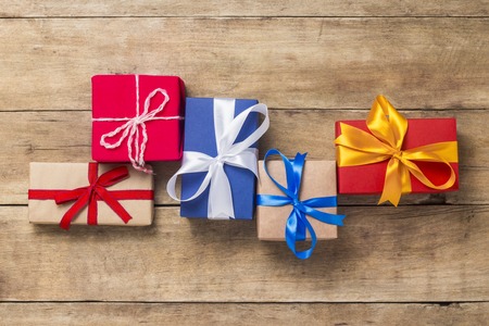 Many gift boxes on wooden background. Holiday concept, New Year, Christmas, Birthday, Valentine's...