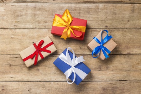 Many gift boxes on wooden background. Holiday concept, New Year, Christmas, Birthday, Valentine's...