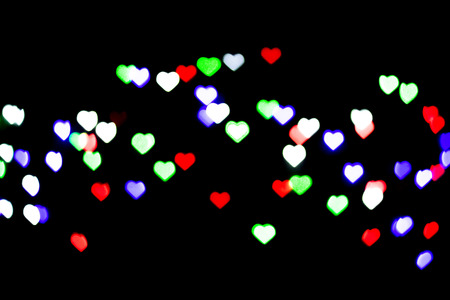 Multicolored bokeh on black background. Heart shape. Love Concept, Valentine's Day. Can be used as a...
