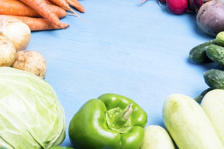 Fresh organic farm vegetables, Health care, on a blue wooden background. Harvest. Country style....