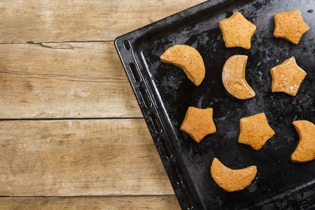 Handmade cookies on a baking sheet on a wooden background. Flat lay, top view