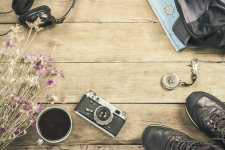 Boots, backpack, compass and other camping gear on a wooden background. The concept of hiking in the mountains or the forest, tourism, tent rest, camp. Flat lay, top viewの写真素材